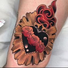 a tattoo on the leg of a woman with roses and sunflowers in it