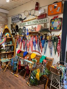 a room filled with lots of different types of ribbons and hats hanging on the wall