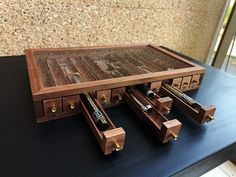 a wooden table topped with lots of drawers