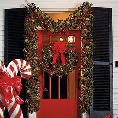 christmas decorations and candy canes on the front porch