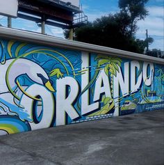 there is a mural on the side of a building that says strando and it's painted in bright colors