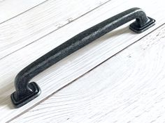 a black handle on a white wooden door