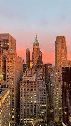 the city skyline is lit up at night, with skyscrapers in the foreground