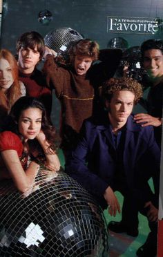 a group of people standing around a disco ball