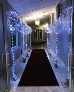 a hallway decorated with blue lights and decorations