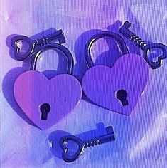 two heart shaped locks and a key on a purple background