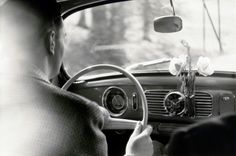 a man sitting in the driver's seat of a car