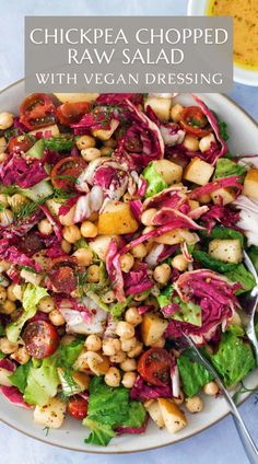 chickpea chopped raw salad with vegan dressing in a white bowl on a blue table