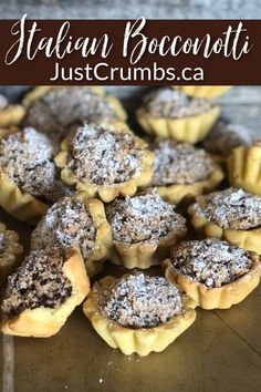 small pastries with powdered sugar in them on a wooden surface and text that reads italian bocconuti just crumbs ca