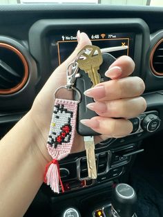 a woman holding a car key chain in her hand