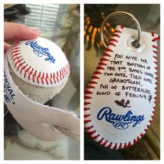 a baseball keychain that has some writing on it and is being held by someone's hand