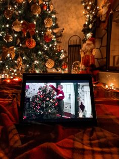 a christmas tree is shown in front of a television