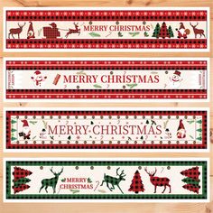 three christmas banners on a wooden surface