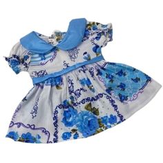 Blue flower print dress features short puff sleeves and a gathered skirtA blue collar and band at the waist make a pleasant contrastDress closes in the back with VelcroShown on Baby Alive Sweet Tears and Potty Dance who are 14 inch tall with a 10 1/2 inch waistThis listing is for one doll dress the doll is not included Gender: unisex. Vintage Blue Dress With Doll Collar, Spring Blue Dress With Doll Collar, Blue Doll Collar Summer Dress, Blue Summer Dress With Doll Collar, Cute Blue Dress With Peter Pan Collar, Blue Flower Print Dress, Blue Flower Print, Blue Flower Dress, Contrast Dress