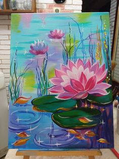 an easel with a painting of pink flowers on it