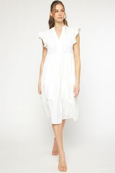 This Ruffled Pocket Tiered Midi Dress is perfect for any occasion! It's lightweight, has fun sleeves that are ruffled to perfection, and can easily be switched from casual to dressy. Forget a closet full of options-- this dress has you covered! This dress features a v-neck, placket, ruffled cap sleeves, pockets, is lined and has a tiered flowy midi silhouette. It's the perfect additional to your wardrobe. Small Bust 38" Length 44" : Medium Bust 40" Length 44" Large Bust 42" Length 44" : XL Bust Casual Midi Dress With Ruffle Sleeves For Brunch, Casual Midi Dress With Ruffle Sleeve For Spring, Chic Cotton Midi Dress With Ruffles, Ruffled Flutter Sleeve Midi Dress For Vacation, Spring Cotton Midi Dress With Ruffle Hem, Flutter Sleeve Midi Dress With Ruffles For Vacation, Chic Cotton Tiered Dress With Ruffle Hem, Spring Midi Ruffle Dress For Day Out, Summer Midi Dress With Ruffle Hem For Daywear