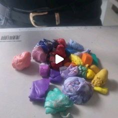 there are many different colored candies on the counter