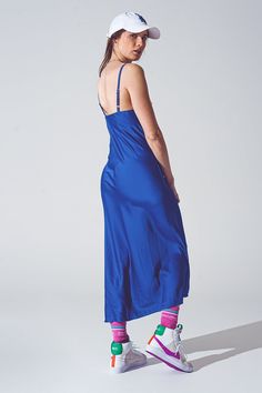 Introducing our stunning Satin Dress with Waterfall Neckline in Blue - the perfect dress for any party or special occasion. This dress features a midi length that falls just below the knee, creating a sophisticated and elegant look. The sleeveless style is perfect for warm weather events or for layering under jackets or cardigans during cooler months. The standard fit ensures that the dress is comfortable to wear, and the adjustable back strap allows for a customized fit. The waterfall neckline Blue Sleeveless Satin Dress, Blue Satin Silk Dress With V-neck, Blue Sleeveless Satin Slip Dress, Elegant Blue Satin Slip Dress, Blue Satin Midi Slip Dress, Blue Slip Dress, Blue Satin Dress, Cobalt Blue Dress, Satin Cami