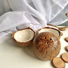 two coconuts and some coins on a table