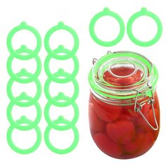 a jar filled with lots of red tomatoes next to some green plastic o - rings