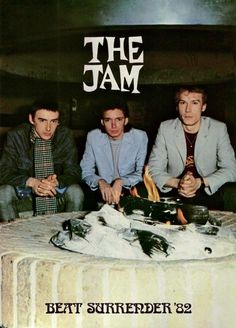 three young men sitting around a fire pit on the cover of an album called the jam