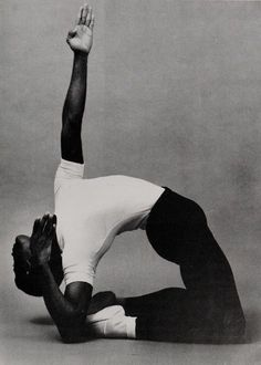 a black and white photo of a man doing yoga