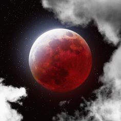 a red moon in the sky with clouds around it