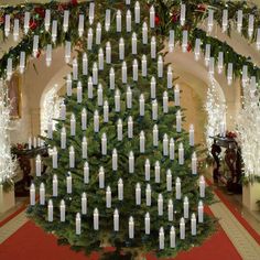 a christmas tree decorated with candles and lights