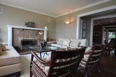 a living room filled with furniture and a fire place in the middle of a room