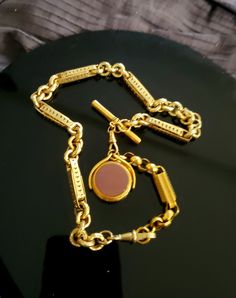 "This incredible Antique 9K gold fob chain stands out not only because of its beautiful design but also for its boldness and solid weight. The chain is made up of 2 sections which can be separated and worn as both a longer necklace with the pendant or just a shorter (15\") choker chain. The pendant drop is on a swivel and is reversible one side being a bloodstone and the other sardonyx. Please note that while the chain itself is 9K gold the drop swivel pendant is gold filled. As noted this chain Fob Chain Necklace, Memorial Ring, Choker Chain, Antique Rings, Tiffany & Co., Long Necklace, Antique Gold, Chains Necklace, Beautiful Rings