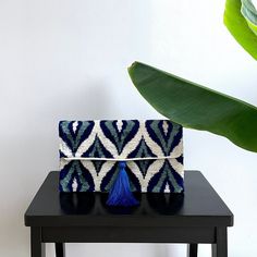 "Mila∞Miro by Emelie  * Chic clutch bag in handloomed fabric  * Lightweight, soft and suitable for phone, keys, purse  * Made of 100% silk velvet ikat  * Magnetic snap closure, silk tassel  * Can be ordered without or with chain (110 cm)  * Size 17x30 cm / 6.7\" x 11.8\"  * Worldwide delivery within 1 week  * Free shipping!  Kindly note: - These bags are made-to-order. Position of pattern can differ from product pictures displayed. Colors in reality may also differ a bit depending on angle, light and the screen of your device. - Dry clean only. - Ikat is an exquisite fabric, every piece is unique and can contain small imperfections; the charm of a handmade product. - Items are expressed shipped. Customs duties may apply. - Products are subject to availability. - Many of the fabric designs Beaded Pouch, Fabric Designs, Envelope Bag, Ikat Fabric, Beaded Clutch, Beaded Bags, Silk Velvet, Product Pictures, Picture Display