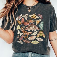 Step into the whimsical world of nature with our Botanical Cottagecore tee! Designed for dark academia souls, this enchanting shirt flaunts a delightful array of moths and butterflies. Embrace the magic and show off your unique style in this comfy oversized tee. A perfect  gift for anyone who loves cottagecore or goblincore Comfort Colors introduces its garment-dyed t-shirt made 100% with ring-spun cotton. The soft-washed, garment-dyed fabric brings extra coziness to your wardrobe while the relaxed fit makes it an excellent daily choice. The double-needle stitching throughout the tee makes it highly durable while the lack of side-seams helps the shirt retain its tubular shape. .: 100% ring-spun cotton .: Medium fabric (6.1 oz/yd² (206.8 g/m .: Relaxed fit .: Sewn-in twill label Fairy Grunge Cotton T-shirt With Graphic Print, Cotton Fairy Grunge Top With Graphic Print, Fairy Grunge Cotton Top With Graphic Print, Fairy Grunge Graphic T-shirt For Summer, Fairy Grunge Cotton Tops With Crew Neck, Summer Fairy Grunge T-shirt With Crew Neck, Green Fairy Grunge Tops For Spring, Cotton Multicolor Tops With Butterfly Print, Grunge Cotton Tops With Custom Print