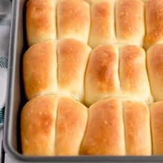 a pan filled with bread rolls sitting on top of a table