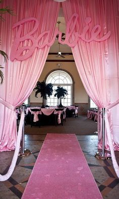 the entrance to a wedding reception with pink drapes