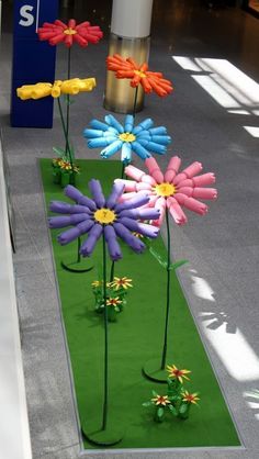 colorful fake flowers are placed in the grass