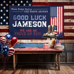 an american flag and boots are on a table with balloons in front of a sign that says, good luck jameson we are so proud of you