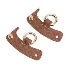 two brown leather clips with gold rings on each end and one has a metal hook in the middle