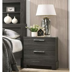 a night stand with two drawers and a lamp