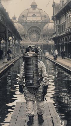 an old photo of a man with a backpack on his back walking in the rain