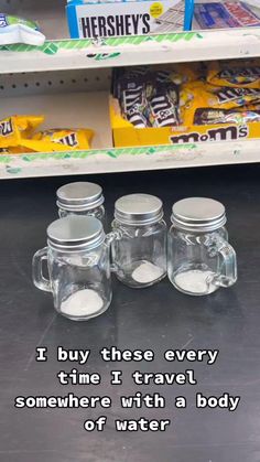 four glass jars sitting on top of a counter next to each other with the words i buy these every time it travel somewhere with a body of water