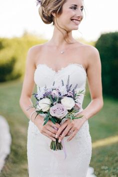 a woman in a wedding dress holding a bouquet