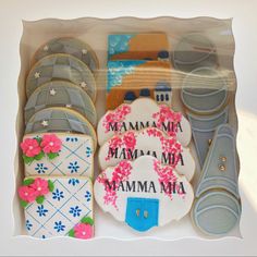 decorated cookies in a box with the words mamma mia and matching cookie cutters