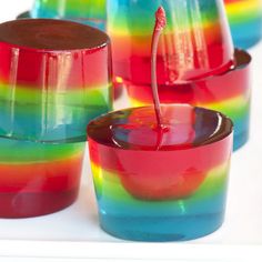 several glasses with different colored liquids in them