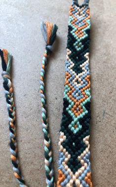 two pieces of beaded bracelets sitting on the ground