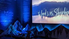 there is a projection screen that says the lord is my shepherd in front of mountains