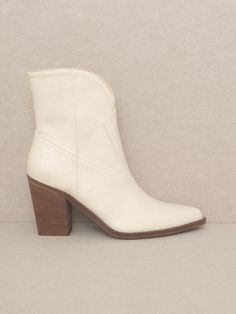 Satisfy your fashion cravings with these Boots Are My Weakness - Harmony Western Booties. These boots offer a stylish and versatile two-panel design with a leg-lengthening dip, perfect to elevate any outfit. Embrace your inner cowgirl with these classic western boots. Color: Beige or Black Fabric: Vegan Leather Brand: Oasis Society Includes: x1 Pair of Boots Sizes: 6, 6.5,7, 7.5, 8, 8.5, 9, 10Shaft Height: 5.55"Heel Height: 3.25"Circumference of Shoe Opening: 10.75"Shaft Circumference: 11" Trendy Boots With Contrasting Heel Counter For Fall, Trendy Pointed Toe Boots With Contrasting Heel Counter, Spring Ankle Boots With Contrasting Heel Counter, Ankle Boots With Contrasting Heel Counter For Spring, Cream Faux Leather Boots Medium Width, Cream Medium Width Faux Leather Boots, Cream Boots With Reinforced Heel And Medium Width, High Ankle Boots With Contrasting Heel Counter, Cream Boots With Stacked Heel For Winter