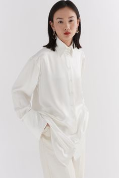 Our Ivory Silk oversized tailored shirt is made of 100% Silk. The shirt features a traditional collar, button stand with mother of pearl buttons and oversized cuffs with our signature button detail. Pink Wide Leg Trousers, Ivory Silk, Red Candy, French Seam, Candy Stripes, Tailored Shirts, Mother Of Pearl Buttons, Pearl Buttons, Poplin Shirt