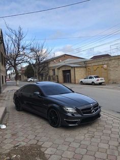 a black car parked on the side of a street