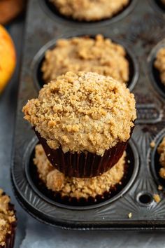 muffins with crumbs sitting in a muffin tin