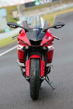 a red motorcycle is parked on the street